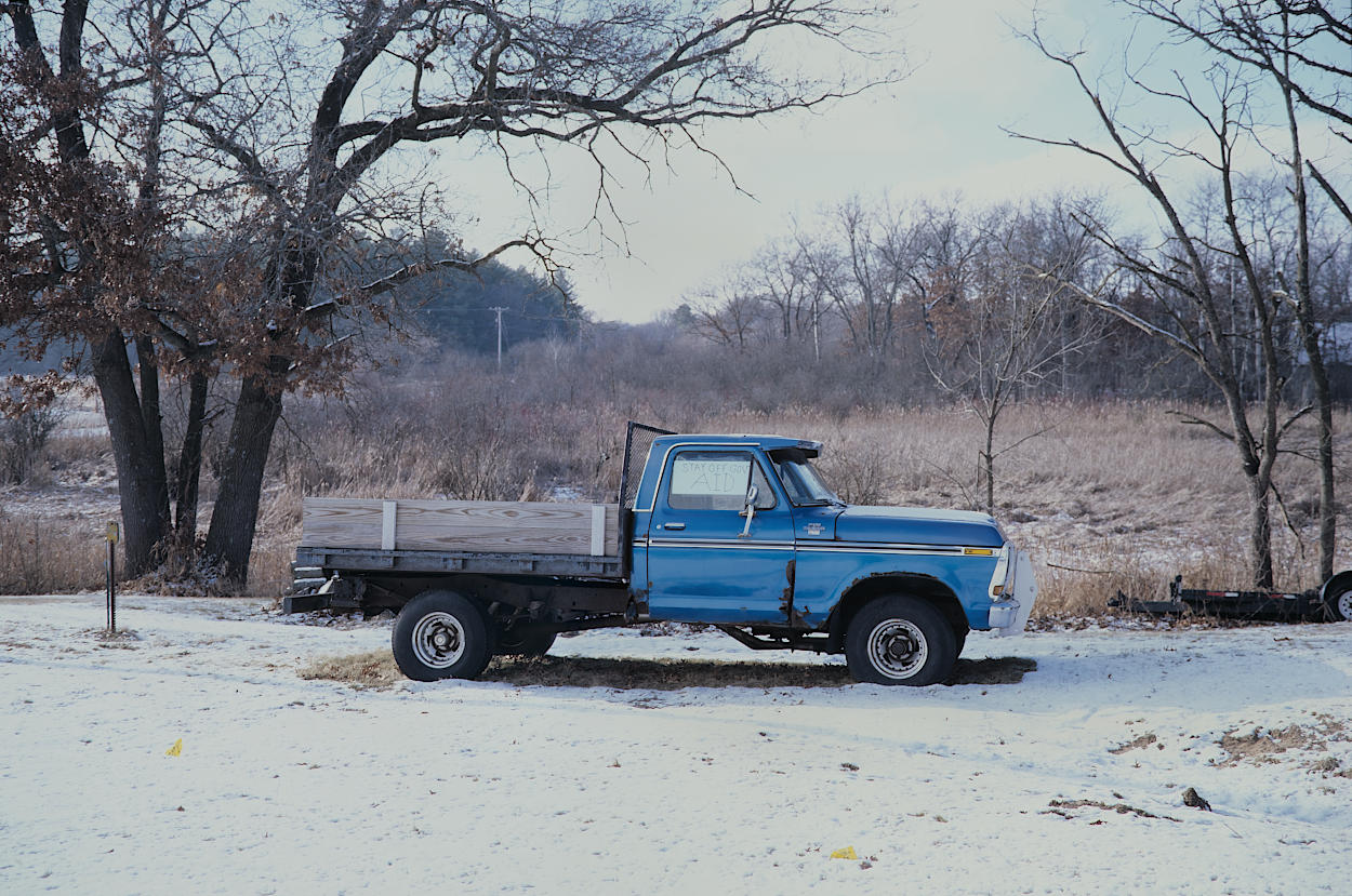 A derelict truck in a barren snowscape